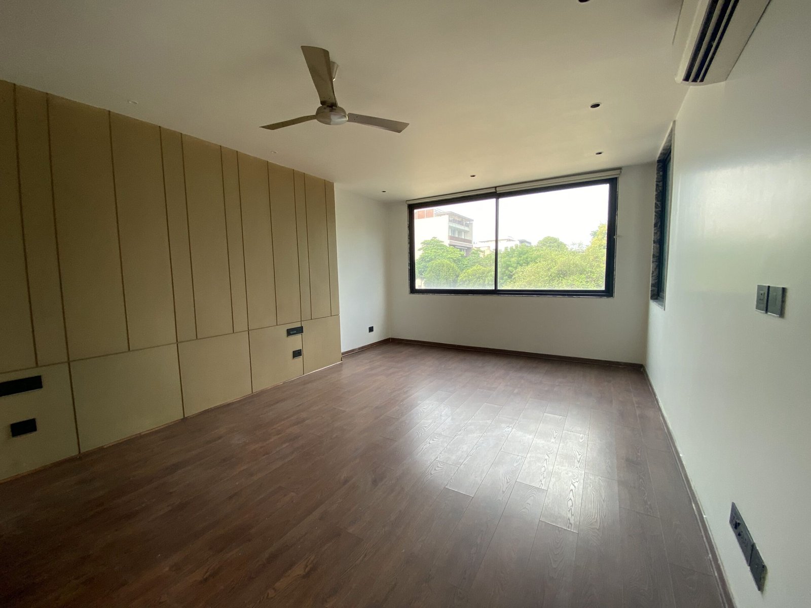 Premium bedroom in a luxury builder floor at Emaar Emerald Hills Sector 65 Gurgaon with wooden flooring and natural daylight